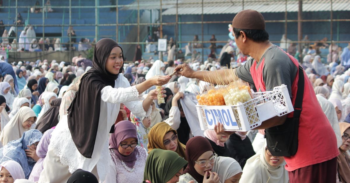 Sebuah kumpulan yang hidup dengan orang-orang menikmati camilan dari seorang penjual di Jawa Barat, Indonesia.